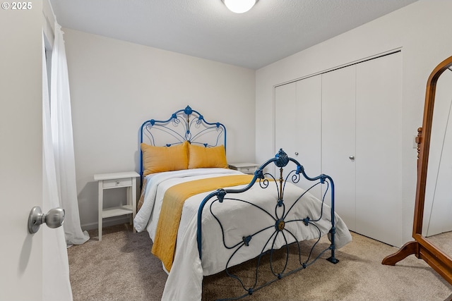 carpeted bedroom featuring a closet and a textured ceiling