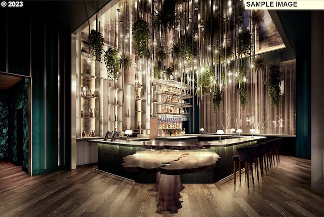 bar featuring dark hardwood / wood-style flooring and a towering ceiling