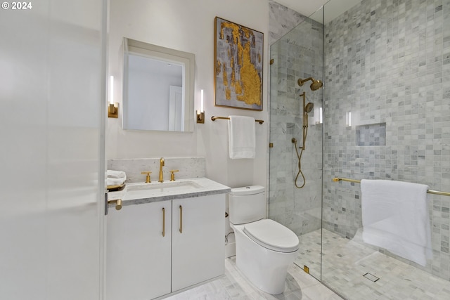 bathroom with vanity, toilet, tile floors, and a shower with shower door