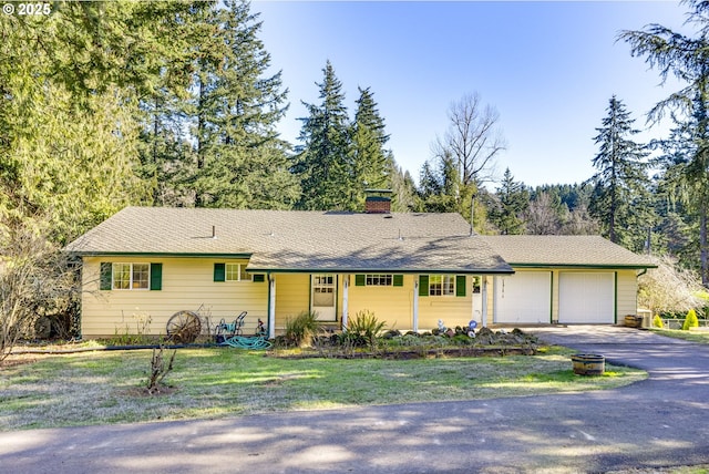 ranch-style home with a garage and a front yard