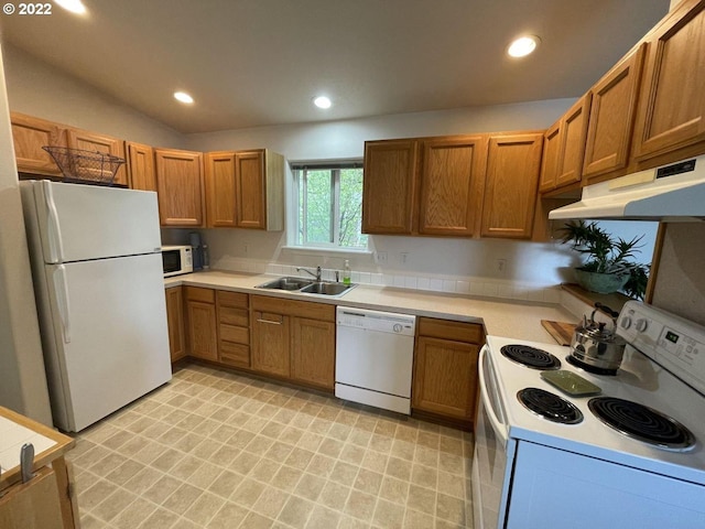 kitchen featuring light tile flooring, sink, white appliances, and lofted ceiling