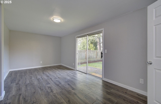 spare room featuring dark hardwood / wood-style flooring