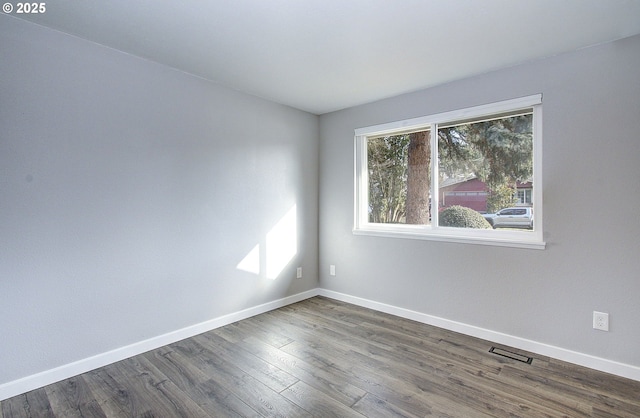 empty room with dark wood-type flooring