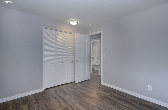 unfurnished bedroom with hardwood / wood-style floors and a closet