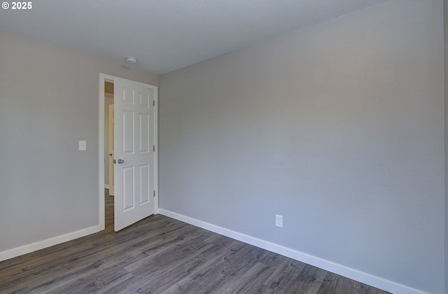 spare room featuring dark hardwood / wood-style flooring