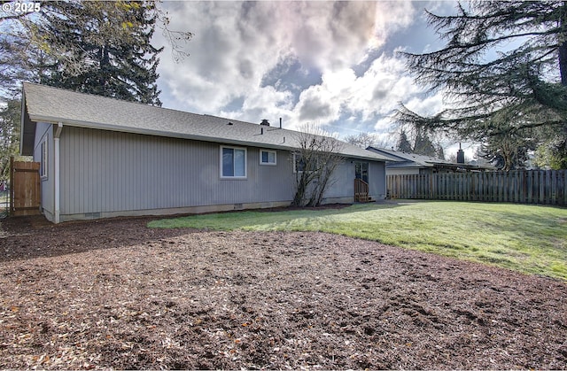 rear view of house featuring a yard