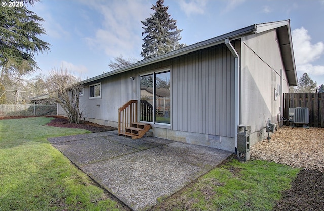 rear view of house featuring a lawn, a patio, and central air condition unit