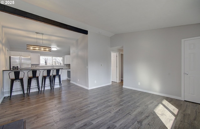 living room featuring hardwood / wood-style flooring, lofted ceiling, and sink