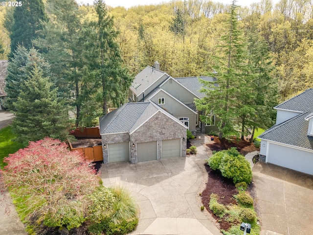 1916 NW Runnymeade Ct, Portland, OR 97229 - view of front of property featuring stone siding, an attached garage, and concrete driveway