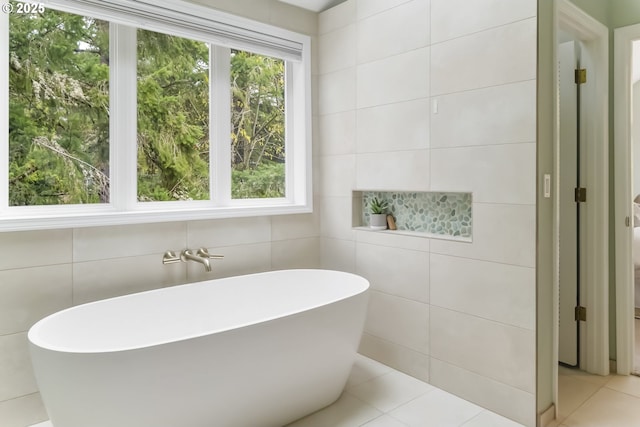 1916 NW Runnymeade Ct, Portland, OR 97229 - full bathroom with tile walls, plenty of natural light, a freestanding tub, and tile patterned floors
