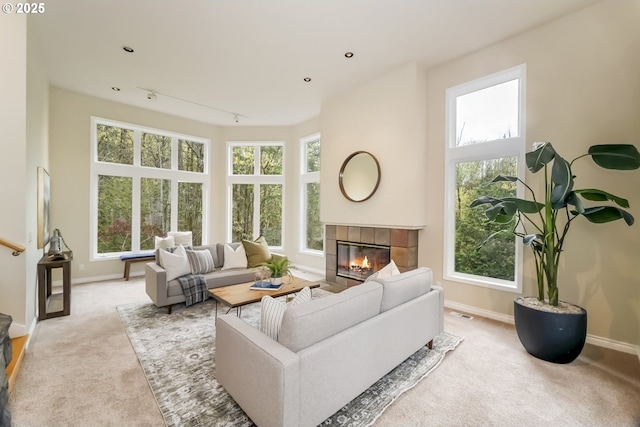1916 NW Runnymeade Ct, Portland, OR 97229 - living room with a tile fireplace, carpet floors, healthy amount of natural light, and baseboards