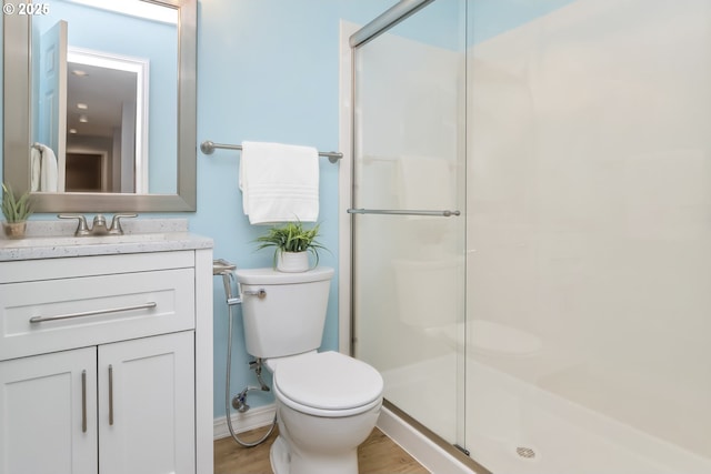 1916 NW Runnymeade Ct, Portland, OR 97229 - bathroom with a stall shower, toilet, wood finished floors, and vanity