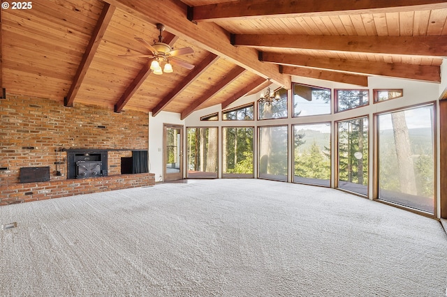 unfurnished living room with wood ceiling, beam ceiling, and carpet