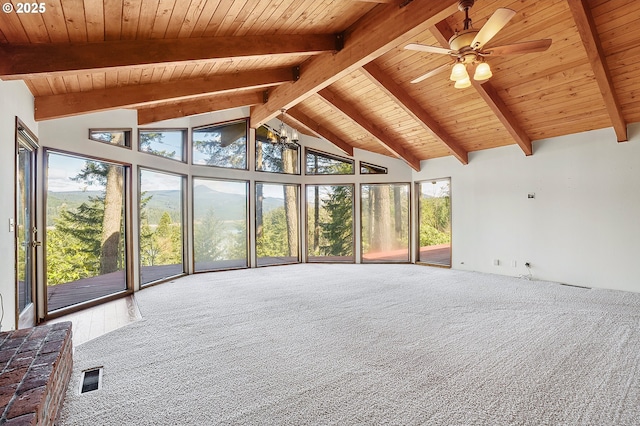 interior space featuring carpet floors, a wealth of natural light, wooden ceiling, beam ceiling, and visible vents