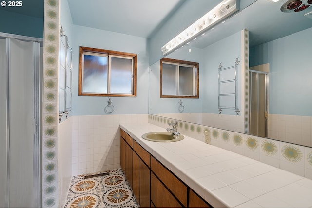 bathroom featuring a shower stall, tile patterned flooring, and vanity