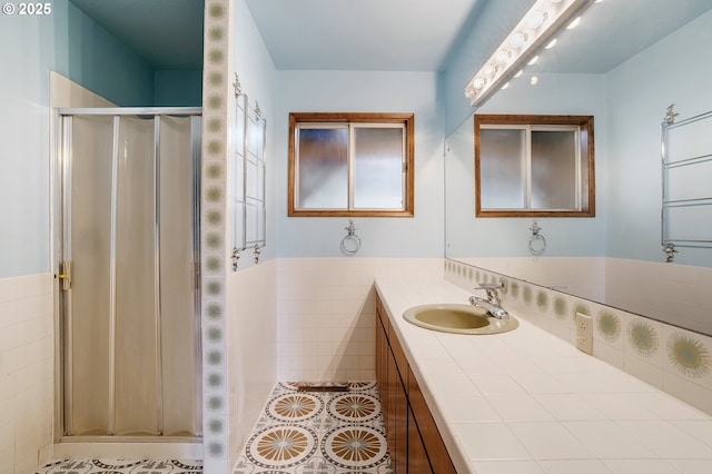 full bathroom with vanity, tile patterned floors, and a stall shower