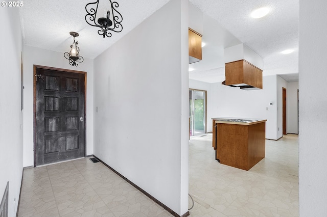 entrance foyer featuring a chandelier and a textured ceiling