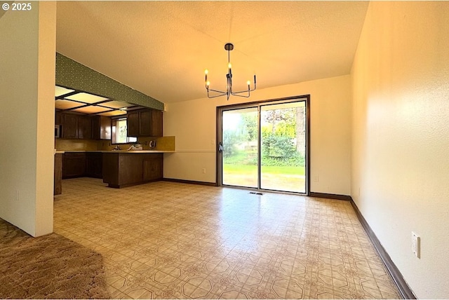 unfurnished dining area featuring baseboards, a notable chandelier, visible vents, and light floors