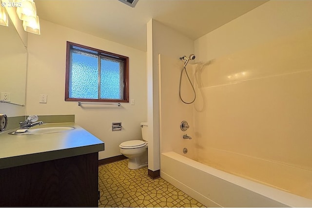 full bathroom with vanity, baseboards, tub / shower combination, and toilet