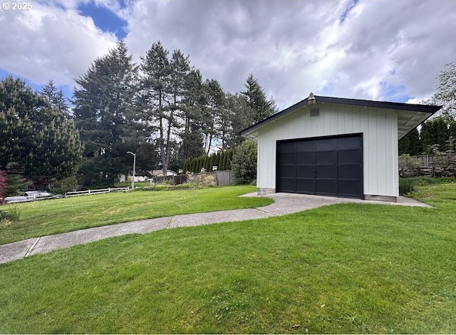 detached garage featuring fence