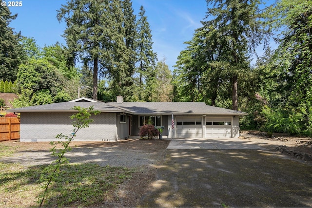 single story home with a chimney, brick siding, fence, aphalt driveway, and an attached garage