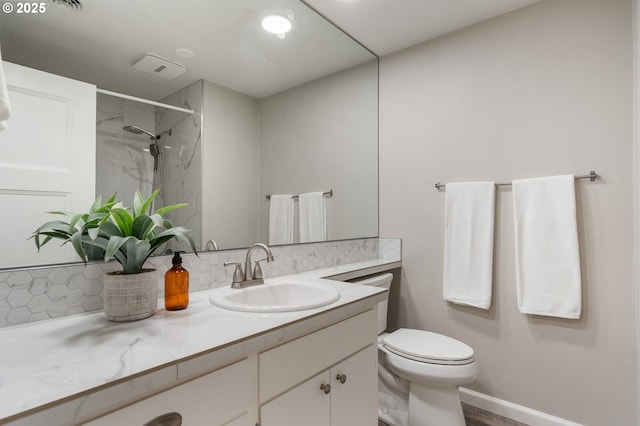 full bath with vanity, toilet, baseboards, tasteful backsplash, and a marble finish shower