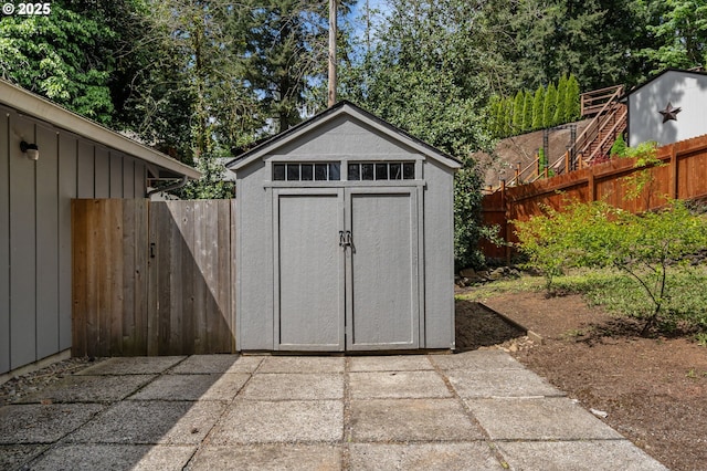 view of shed with fence