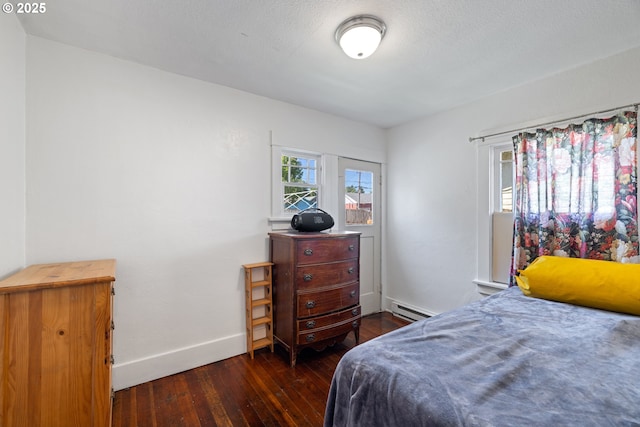 259 18th Ave, Longview, WA 98632 - bedroom featuring a baseboard heating unit, wood-type flooring, and baseboards