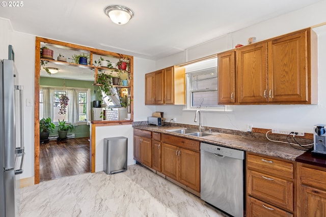 259 18th Ave, Longview, WA 98632 - kitchen featuring stainless steel appliances, a sink, and brown cabinetry