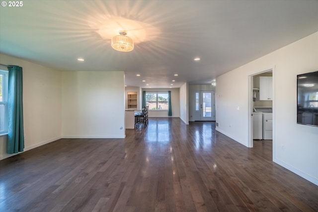 unfurnished living room with baseboards, recessed lighting, dark wood-type flooring, and independent washer and dryer