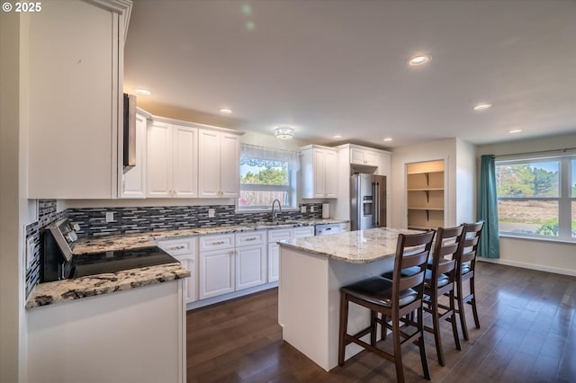 937 Carter St SW, Bandon, OR 97411 - kitchen with stainless steel appliances, white cabinets, dark wood-style flooring, and recessed lighting