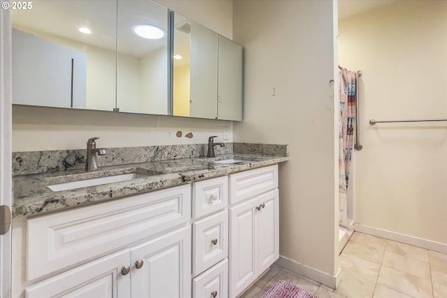 full bathroom featuring a shower with shower curtain, tile patterned flooring, a sink, and double vanity