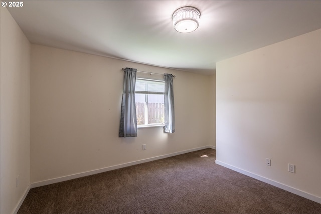 empty room featuring carpet floors and baseboards