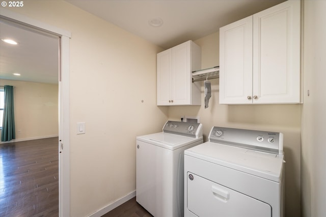 washroom with cabinet space, dark wood finished floors, baseboards, washing machine and dryer, and recessed lighting