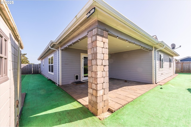 exterior space featuring a patio area, a lawn, and a fenced backyard