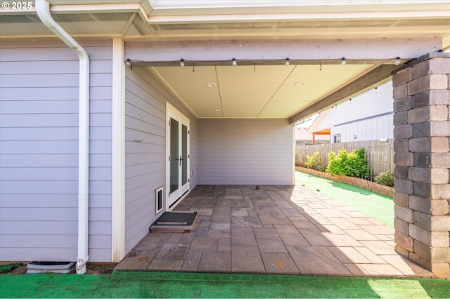 view of patio featuring fence and french doors