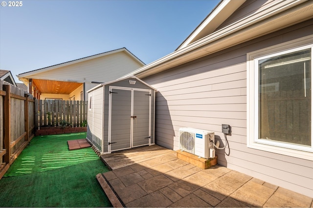 view of patio featuring ac unit, a fenced backyard, a storage unit, and an outdoor structure