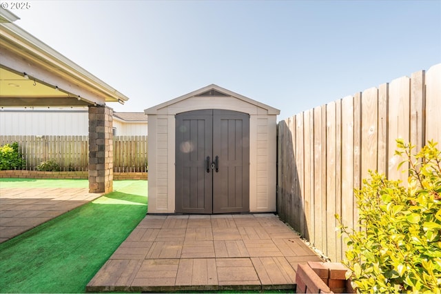 view of shed with a fenced backyard