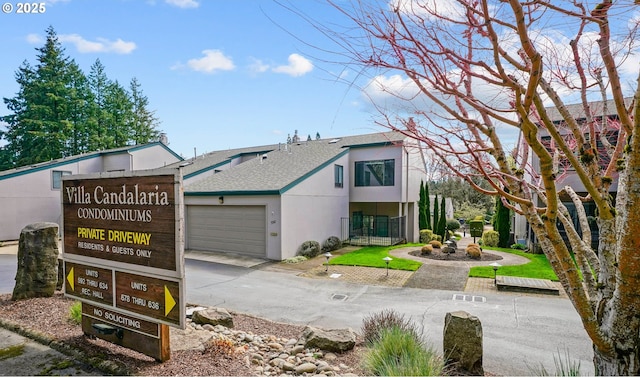 592 Salem Heights Ave, Salem, OR 97302 - view of front of house featuring an attached garage, stucco siding, concrete driveway, and a shingled roof