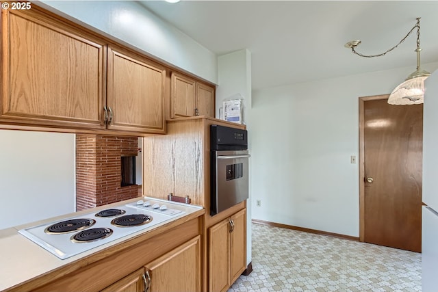 kitchen with white electric stovetop, light countertops, hanging light fixtures, oven, and baseboards