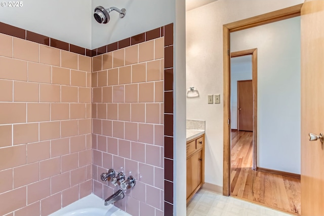 full bath featuring shower / bathing tub combination, vanity, and baseboards