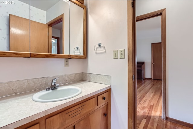 bathroom featuring wood finished floors and vanity