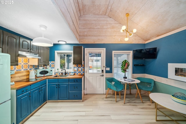 kitchen featuring decorative light fixtures, wood counters, and wood ceiling