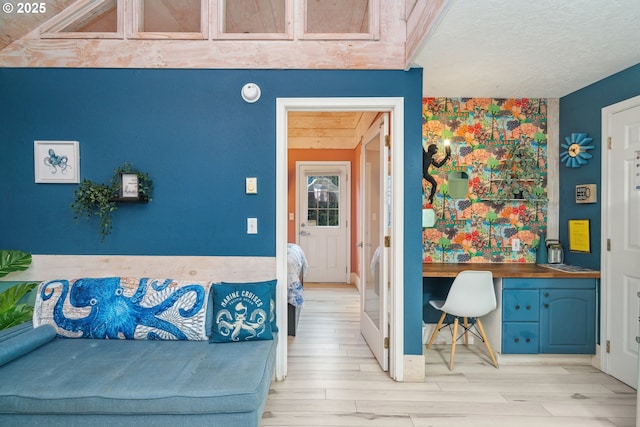 bedroom featuring light hardwood / wood-style flooring and built in desk