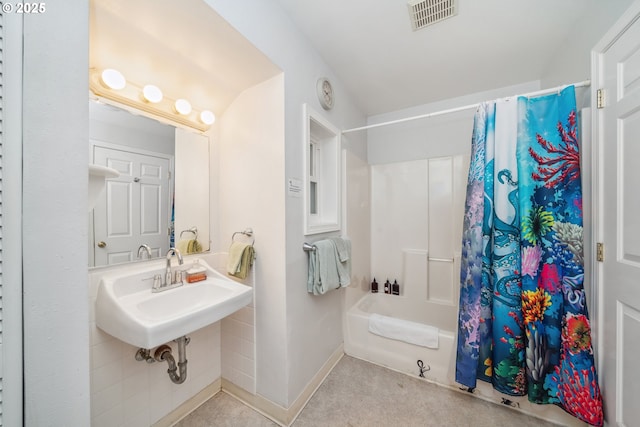 bathroom featuring sink and shower / bathtub combination with curtain