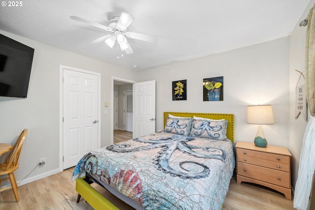 bedroom with light hardwood / wood-style flooring and ceiling fan