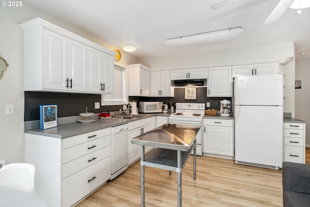 kitchen with sink, white appliances, white cabinets, and light wood-type flooring