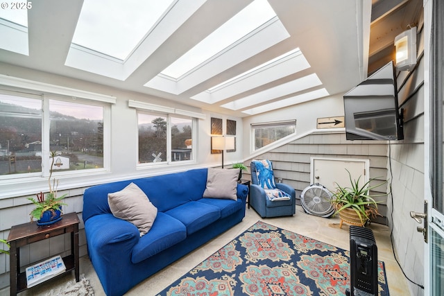 sunroom featuring vaulted ceiling with skylight