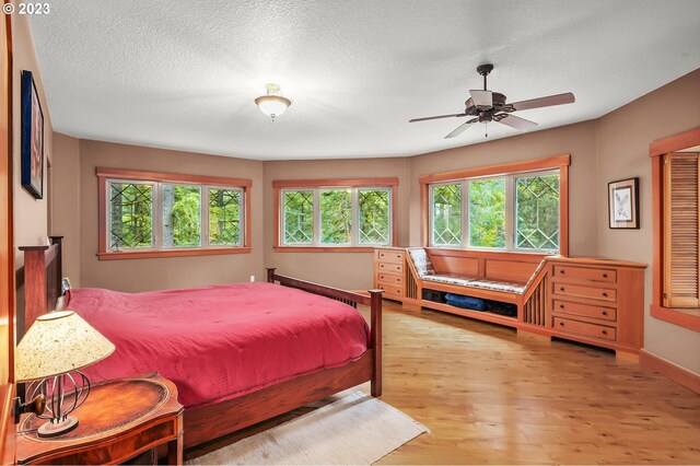 22091 S Ridge Rd, Oregon City, OR 97045 - bedroom with ceiling fan, a textured ceiling, and light hardwood / wood-style flooring