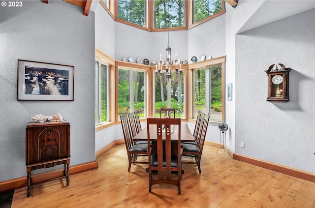 22091 S Ridge Rd, Oregon City, OR 97045 - dining space with light hardwood / wood-style flooring, an inviting chandelier, and a towering ceiling